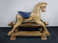A 20th century pine rocking horse with leather saddle