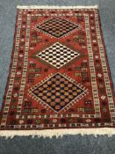 A Persian rug of geometric design,