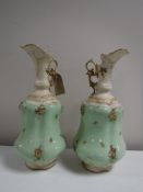 A pair of continental encrusted and gilded ewers