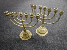 A pair of brass menorahs