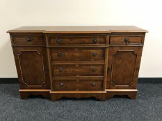 An inlaid yew wood break-front sideboard