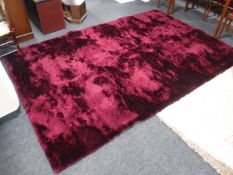 A contemporary maroon coloured rug