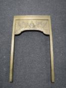 An antique brass fire surround