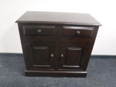 A stained pine double door cabinet