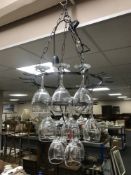 A metal wine glass light fitting with glasses