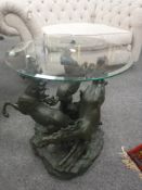 A contemporary glass topped coffee table upon equestrian base,