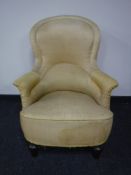 An early 20th century lady's chair upholstered in gold fabric