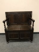 An Edwardian oak hall seat