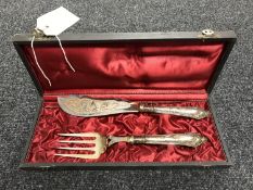 A two piece silver plated serving set in case