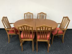 An oval teak extending table and six chairs by Morris of Glasgow