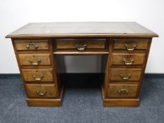 A Victorian walnut leather topped desk fitted nine drawers
