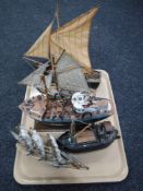 A tray containing five assorted wooden model boats