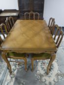An oak French extending table and five chairs