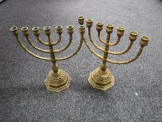 A pair of brass menorahs
