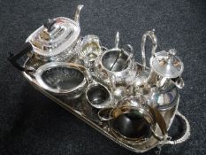 A silver plated twin handled gallery tray on paw feet containing eight miscellaneous pieces of tea