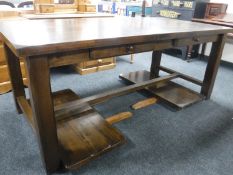 A stained pine dining table fitted two drawers and extension leaves