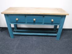 A reclaimed pine three drawer kitchen work table on painted base