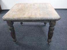 A Victorian carved oak wind out dining table