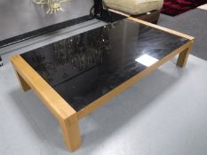 A black glass topped coffee table