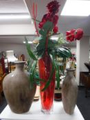 Two pottery vases and a large glass vase of flowers