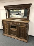 A Victorian heavily carved oak Green Man mirror back sideboard,