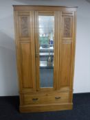 A Victorian satin walnut mirror door wardrobe