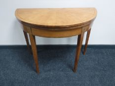 An Edwardian inlaid d-shaped foldover card table