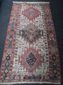 A fringed Eastern rug of geometric design