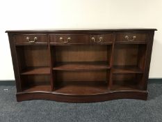 A set of serpentine fronted shelves fitted three drawers