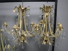 A pair of metal light fitting with glass drops