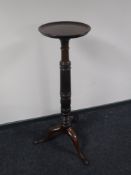 A Victorian mahogany torchere on three way pedestal