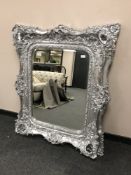 A very ornate silvered bevelled mirror,
