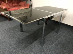 A chrome and black glass dining table
