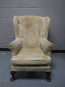 A mid 20th century wing back armchair