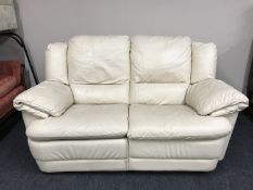 A cream leather two seater settee (one reclining section)