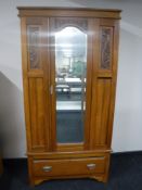 A Victorian satin walnut mirror door wardrobe