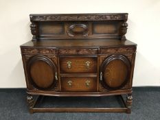 An early 20th century carved buffet back sideboard