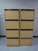 Two wooden four drawer filing cabinets with keys