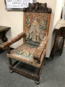 A continental carved oak armchair with tapestry seat,