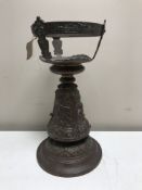 A weighted copper embossed table stand,