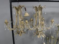 A pair of metal light fitting with glass drops