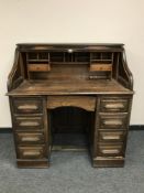 An Edwardian oak roll topped desk,