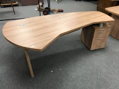 A shaped office desk with pedestal and keys