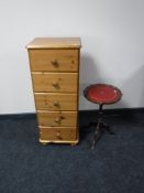 A narrow pine five drawer chest and a wine table