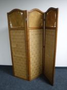 An Edwardian oak triple section screen