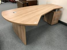 A shaped office desk with pedestal and keys