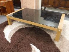 A black glass topped coffee table