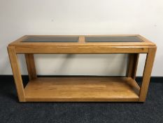 An oak glass topped two tier side table