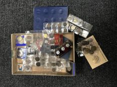 A box containing three coin collector's albums containing coins of the world,