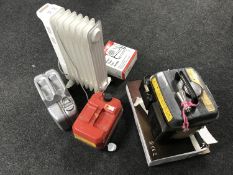 A 850 Watt generator together with two jerry cans, oil filled radiator,